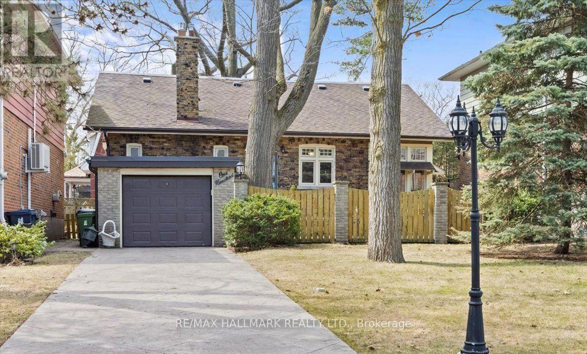 A house with a garage and a driveway in front of it.