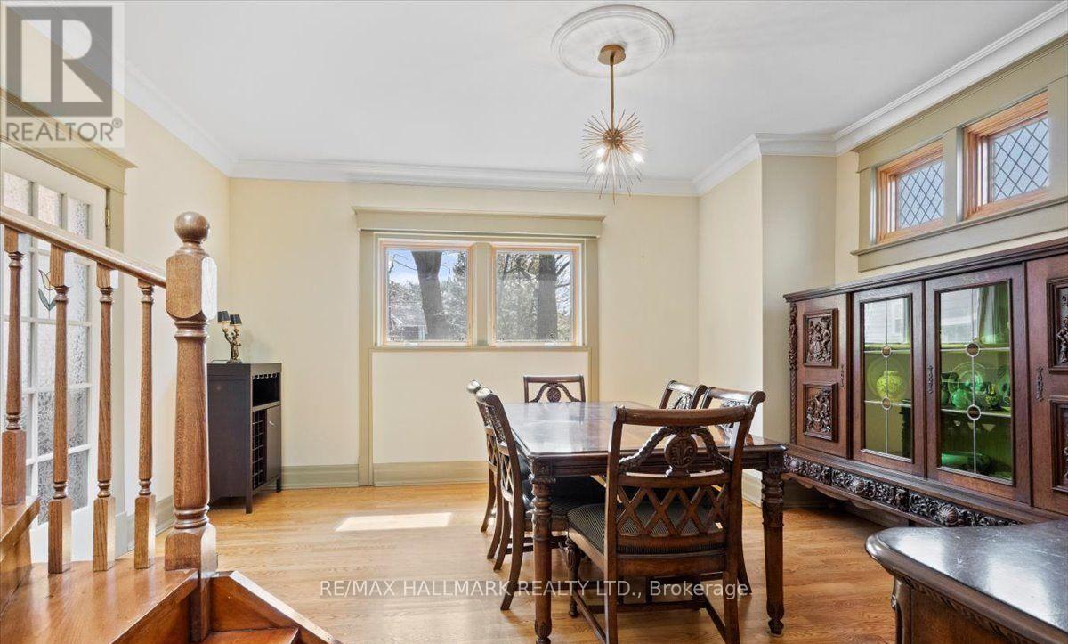 A dining room with a wooden table and chairs.