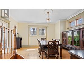 A dining room with a wooden table and chairs.