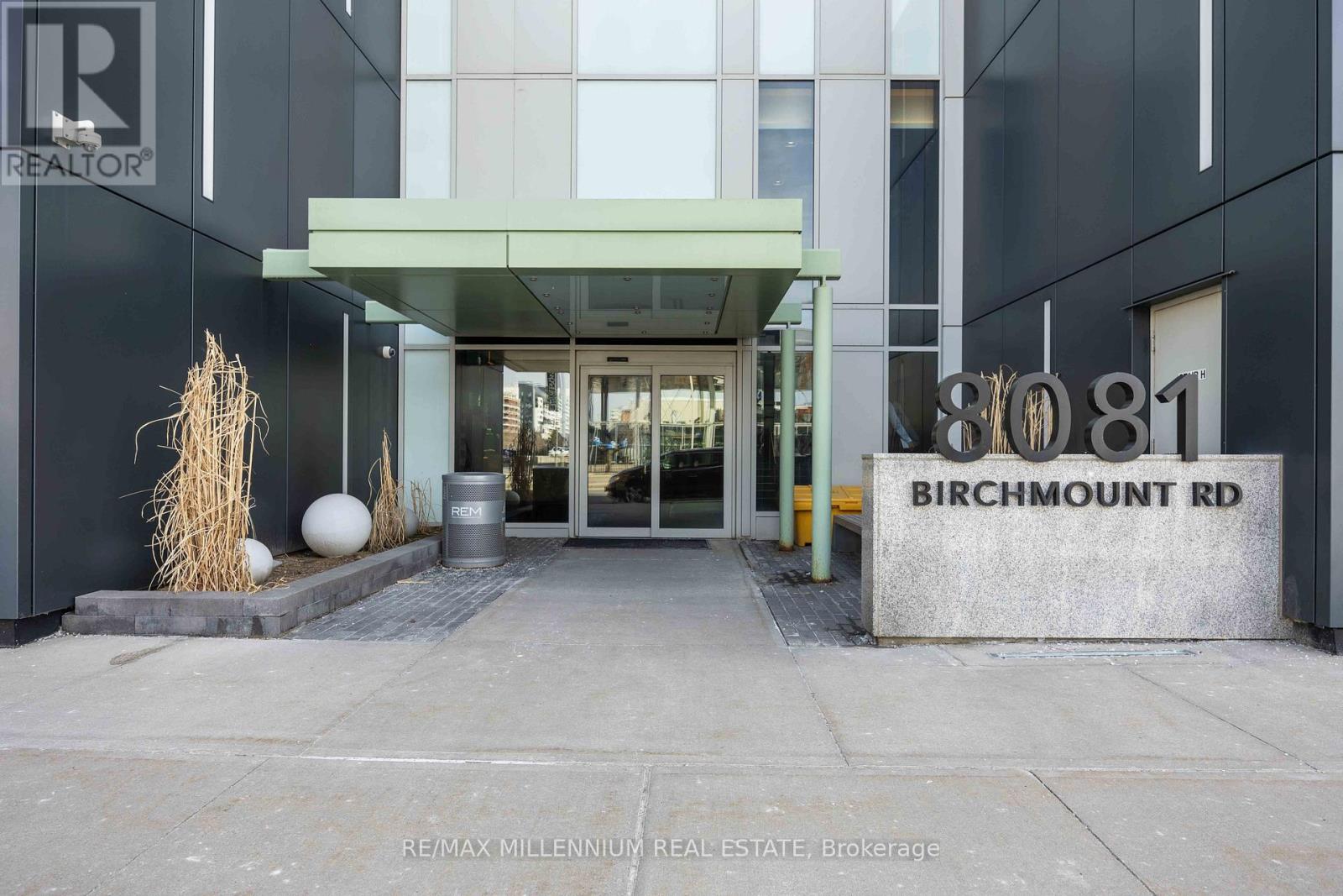 The entrance to a building with the sign "Birchmount Rd" on the wall.