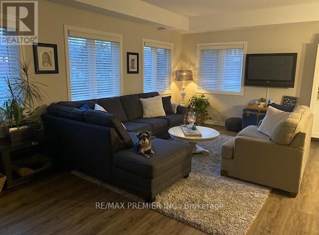 A dog sits on a coffee table in a living room.