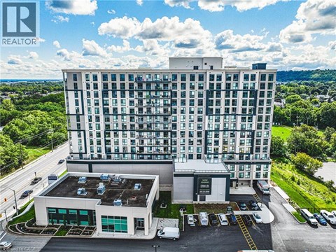 A large white building with a parking lot in front of it.
