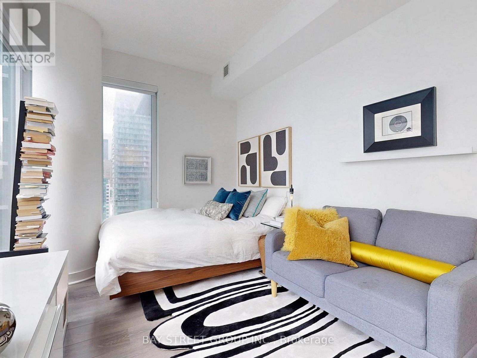 A bedroom with a bed and a couch.
