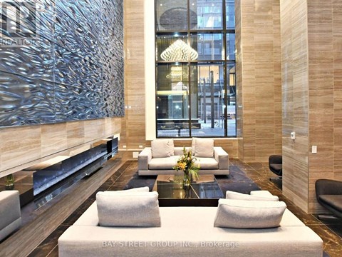 A modern living room with a glass table and white couches.
