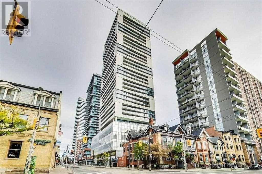 A city street with a mix of modern and older buildings.