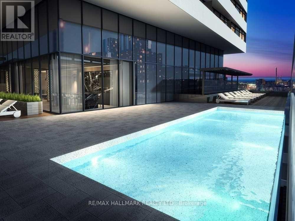 A modern building with a pool in front of it.