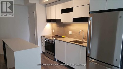 A kitchen with white cabinets and stainless steel appliances.