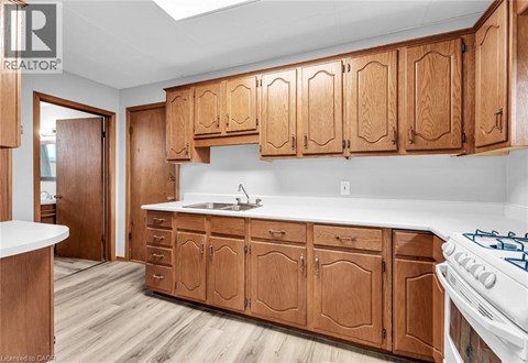 A kitchen with wooden cabinets and a white countertop.
