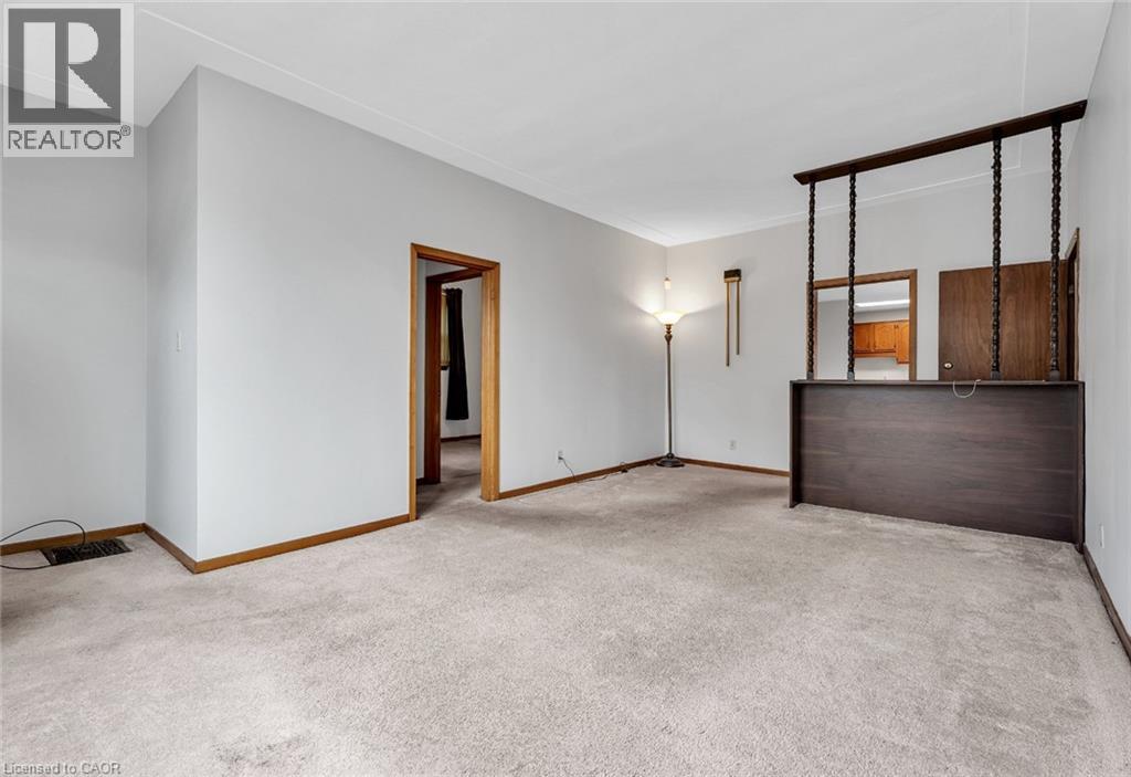 A spacious room with a door, a mirror, and a lamp.