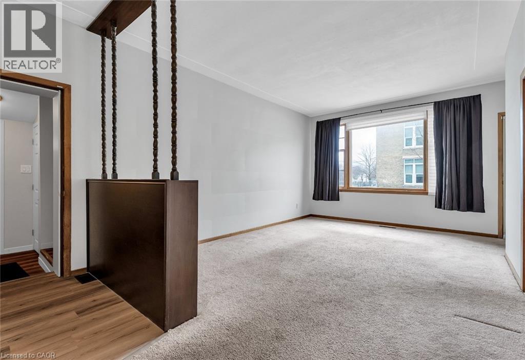 A room with a large window and a wooden floor.