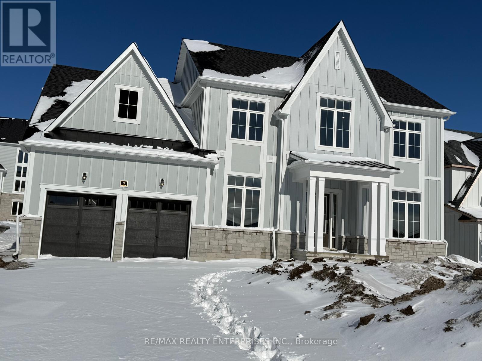 A large house with a snowy front yard.