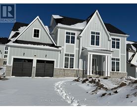 A large house with a snowy front yard.