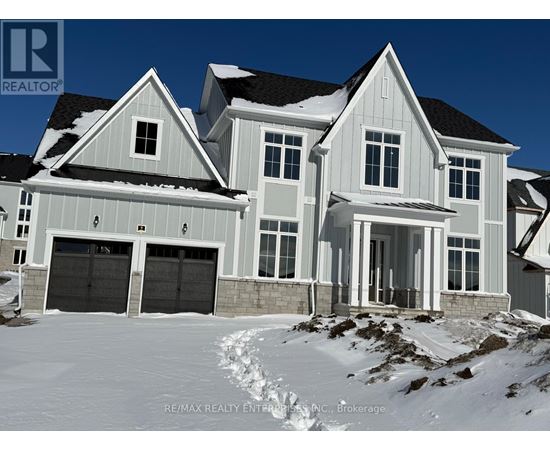 A large house with a snowy front yard.