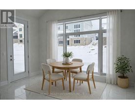 A dining room with a table and chairs in front of a large window.