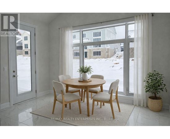 A dining room with a table and chairs in front of a large window.