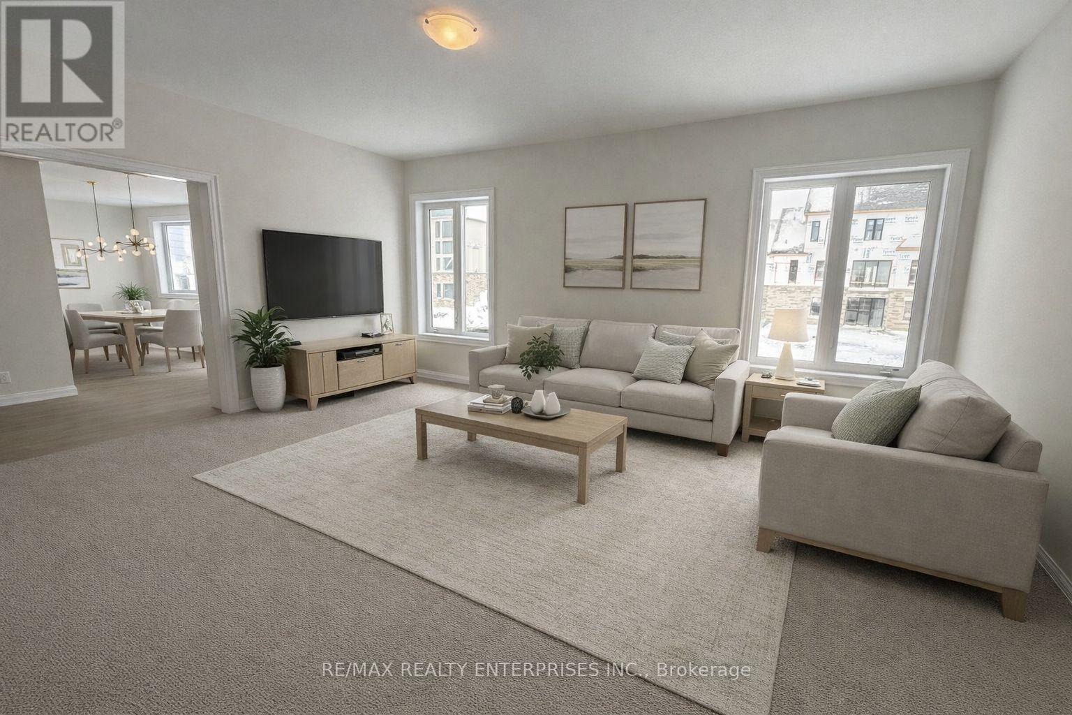 A living room with a grey couch, a wooden coffee table, and a flat screen TV.