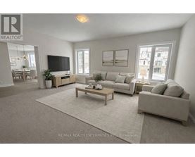 A living room with a grey couch, a wooden coffee table, and a flat screen TV.