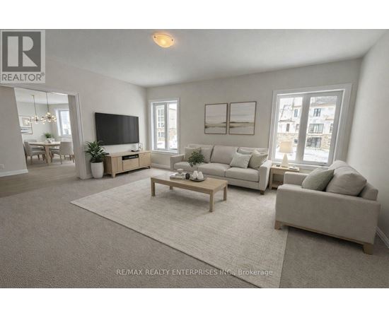 A living room with a grey couch, a wooden coffee table, and a flat screen TV.