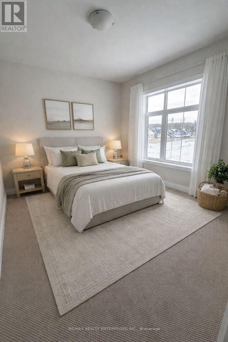 A bedroom with a large bed and two lamps.