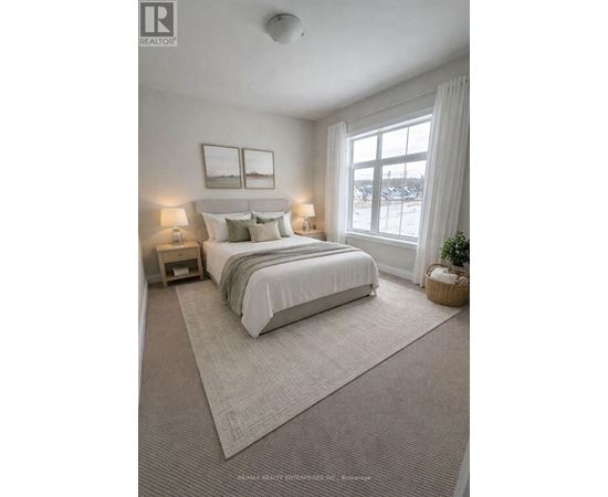 A bedroom with a large bed and two lamps.