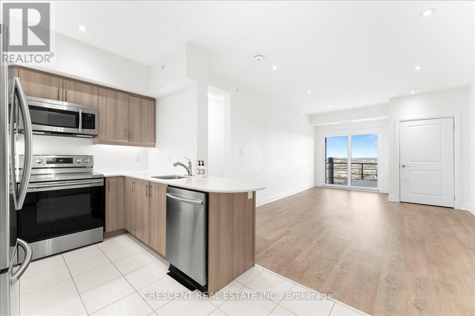 A modern kitchen with wooden cabinets and stainless steel appliances.