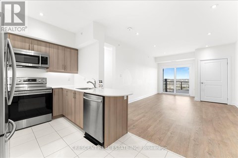 A modern kitchen with wooden cabinets and stainless steel appliances.