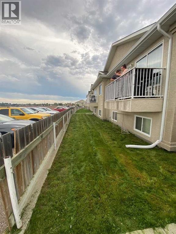 A row of houses with a cloudy sky in the background.