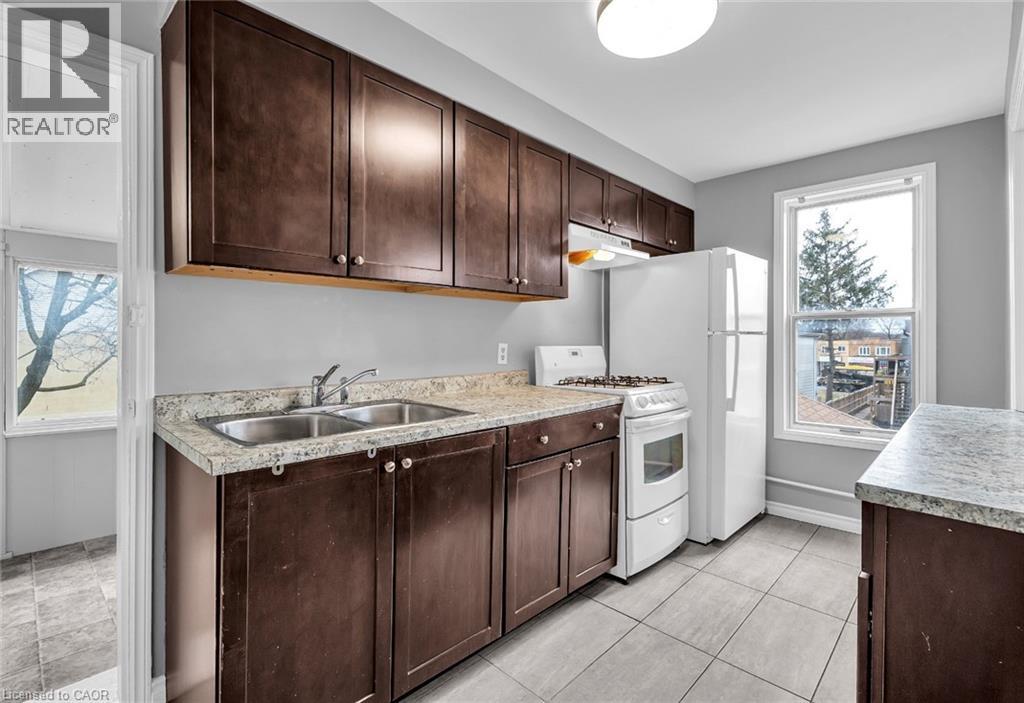 A kitchen with brown cabinets and a white refrigerator.
