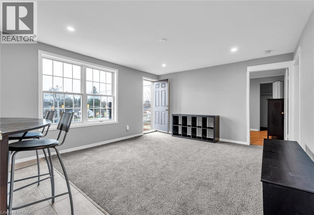A spacious living room with a dining table and chairs.
