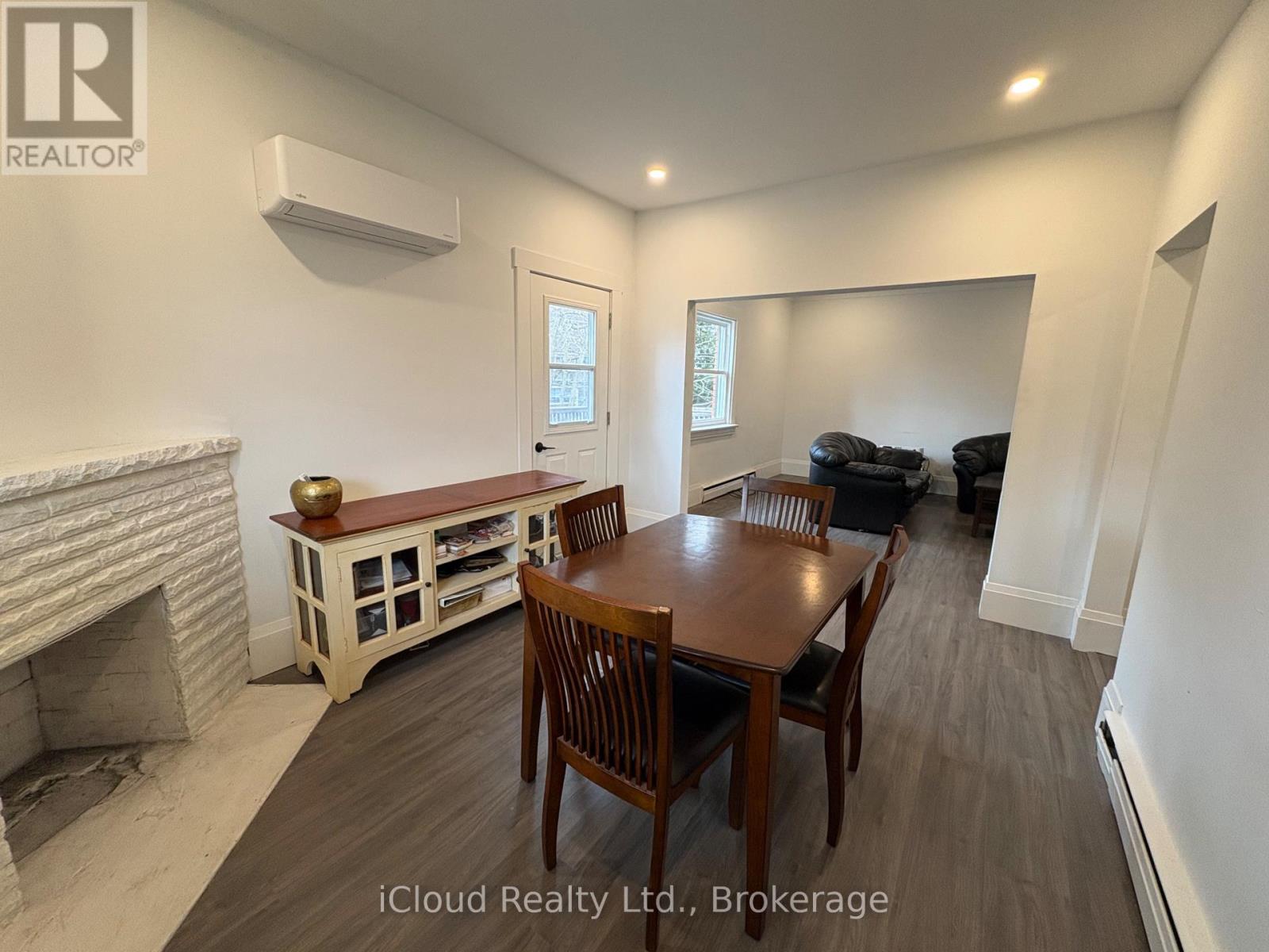 A dining room with a wooden table and chairs.