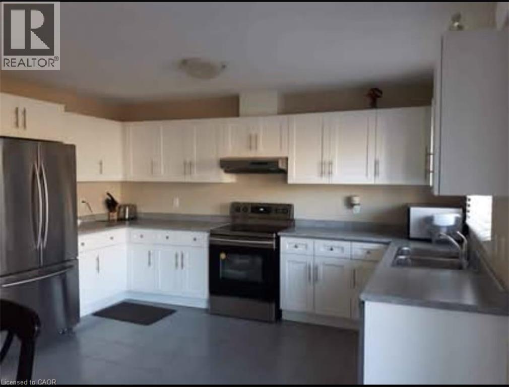 A kitchen with white cabinets and stainless steel appliances.
