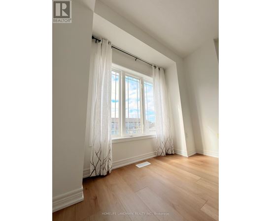 A room with a window and curtains.