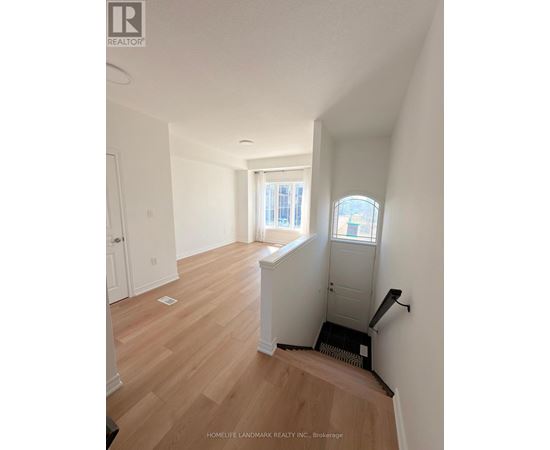 A room with wooden floors and white walls.