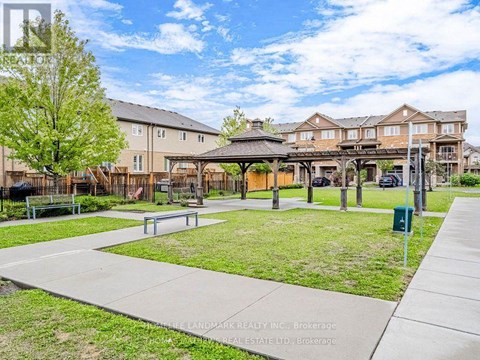 A sunny day at a park with a gazebo and benches.