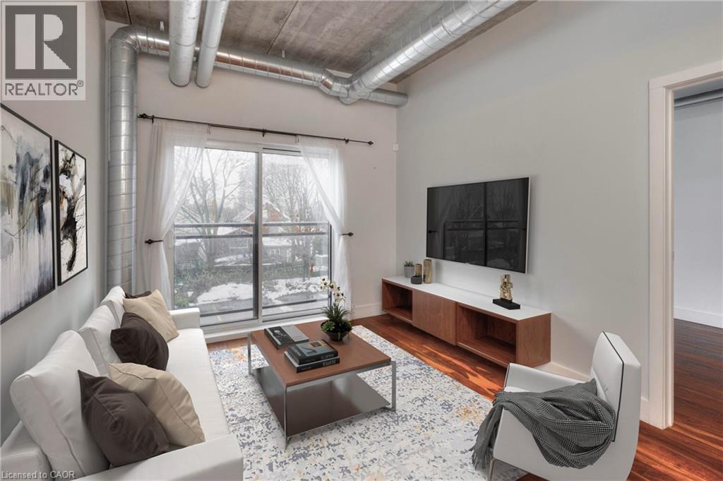 A living room with a couch, a coffee table, and a television.
