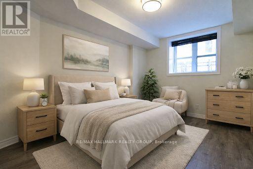 A bedroom with a large bed, nightstands, and a painting on the wall.