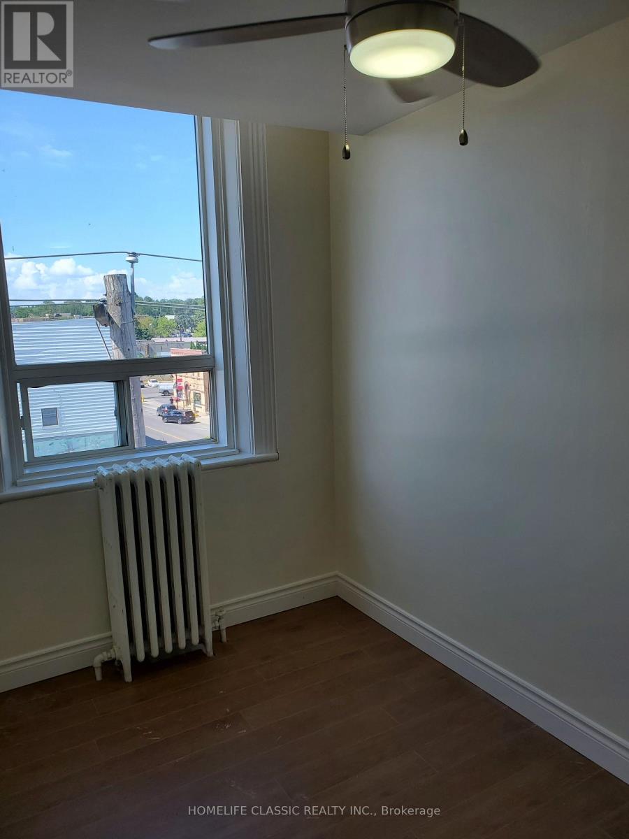 A room with a window and a fan.