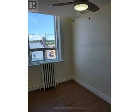 A room with a window and a fan.