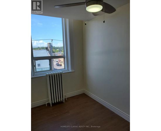 A room with a window and a fan.
