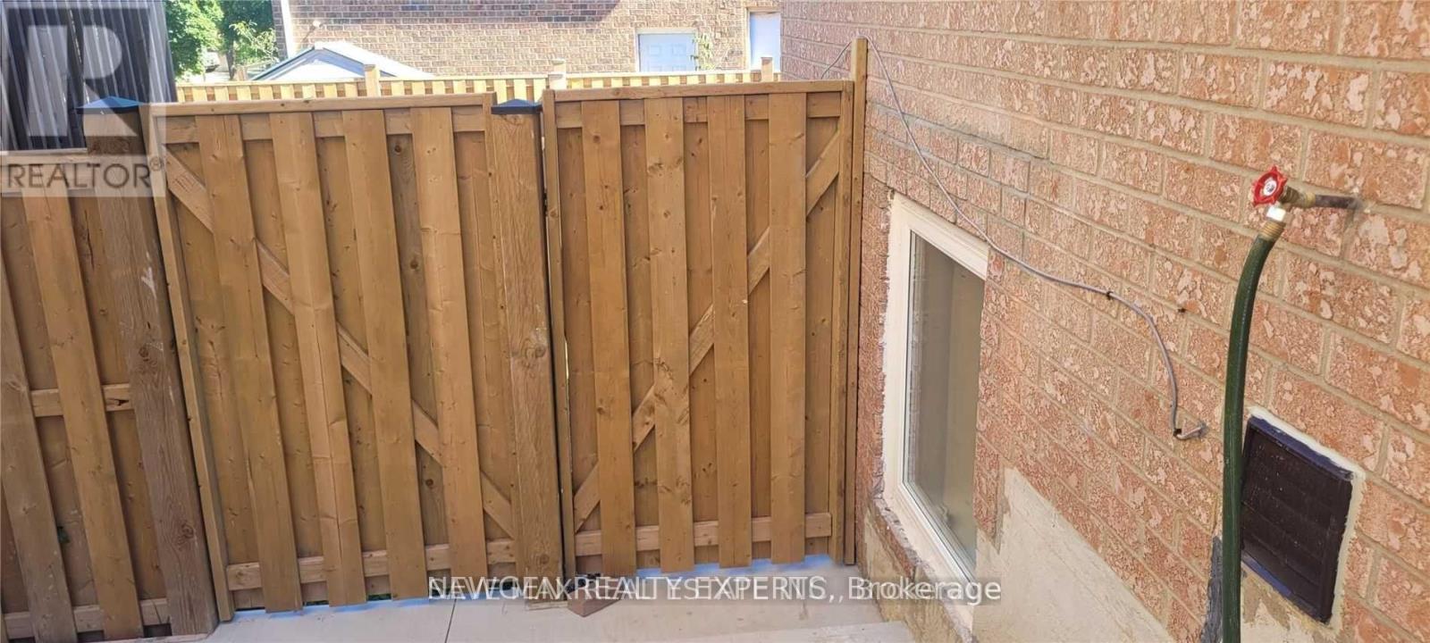 A wooden fence with a sign that says "REALTOR" on it.