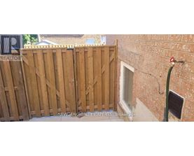 A wooden fence with a sign that says "REALTOR" on it.