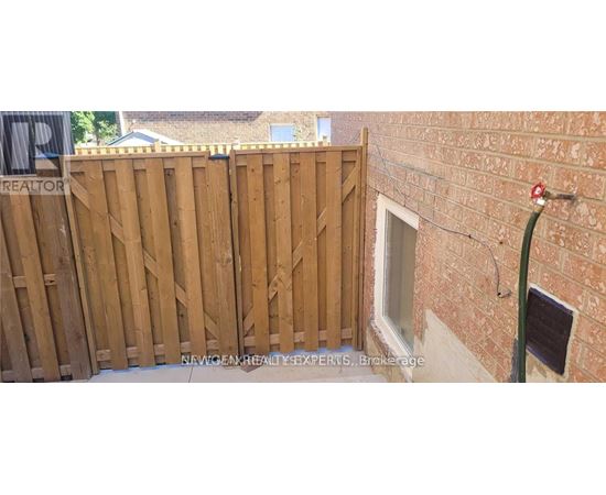 A wooden fence with a sign that says "REALTOR" on it.