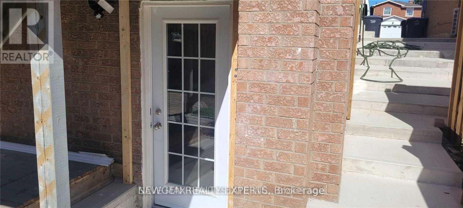 A white door with a glass window is on the left and a white chair is on the right.