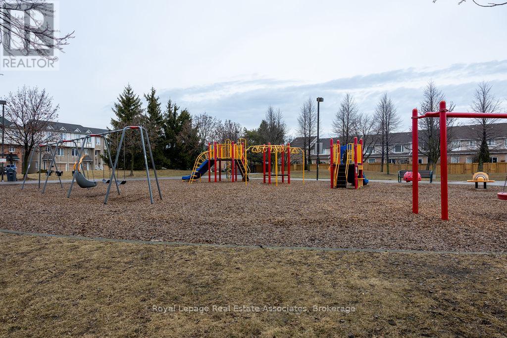 A playground with a red swing set and a yellow slide.