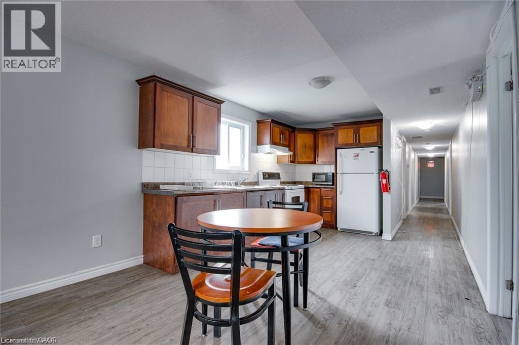 A kitchen with a table and chairs in the foreground and a hallway in the background.