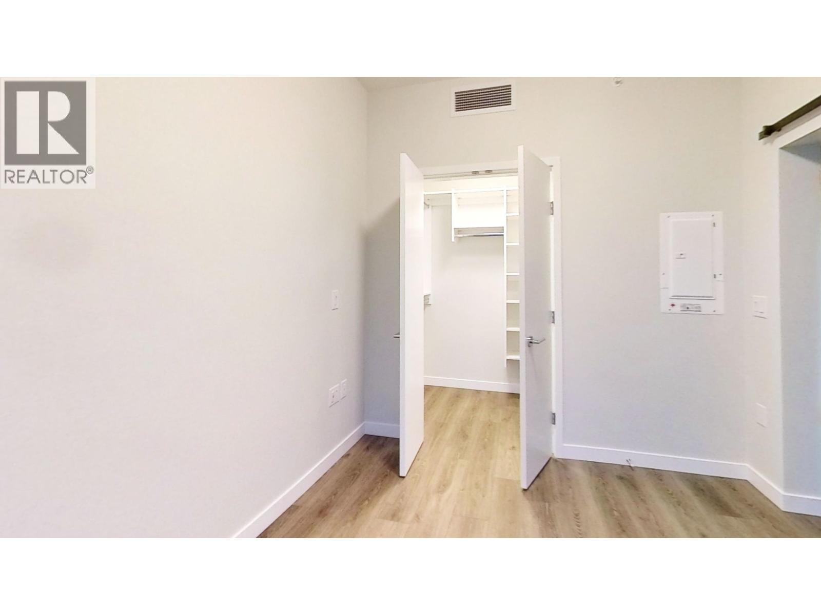 A white door is open to a hallway.
