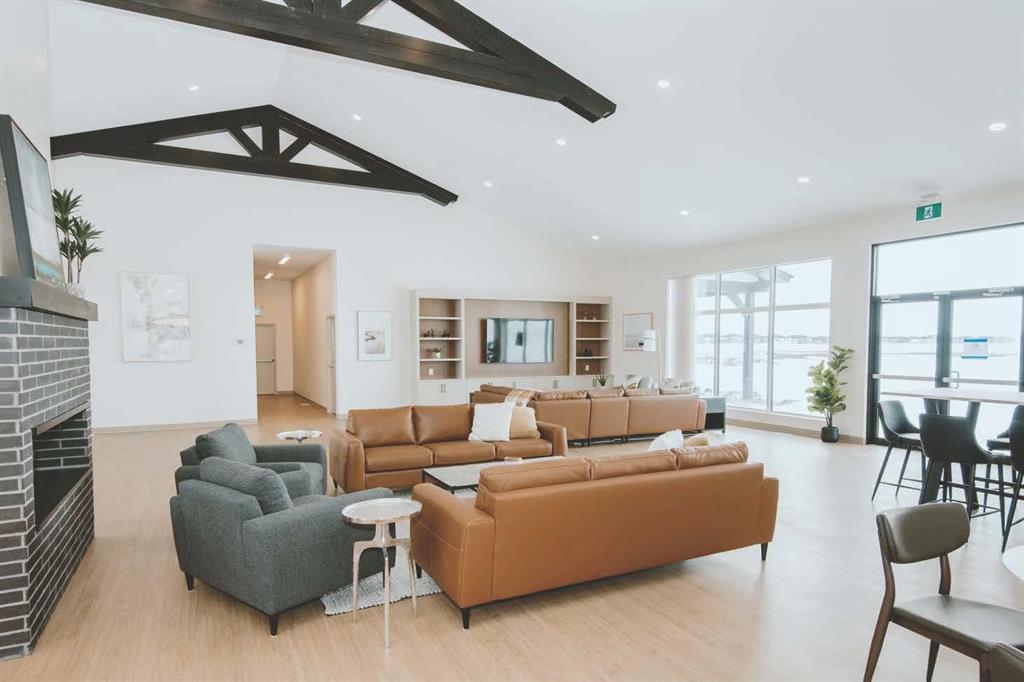 A modern living room with a fireplace and a large window.