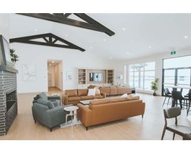 A modern living room with a fireplace and a large window.