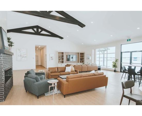 A modern living room with a fireplace and a large window.