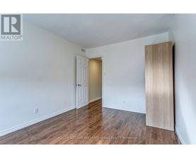 A room with a white door and a wooden door frame.